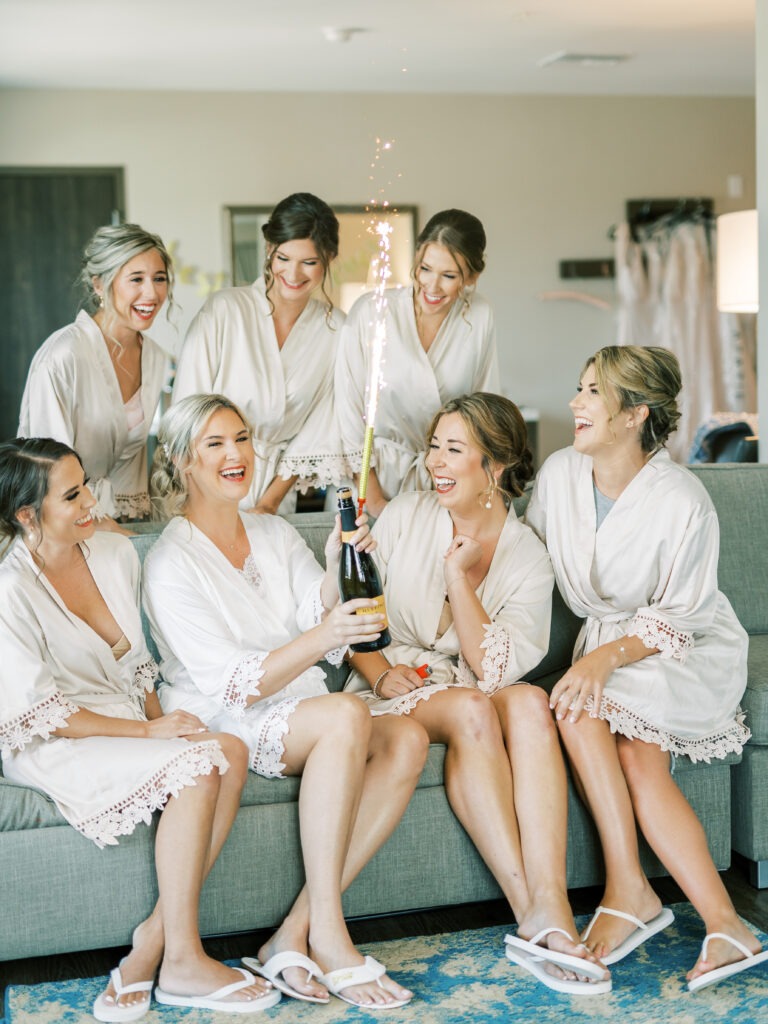 Bridesmaids in Matching Robes Sitting Together in a Hotel Suite
