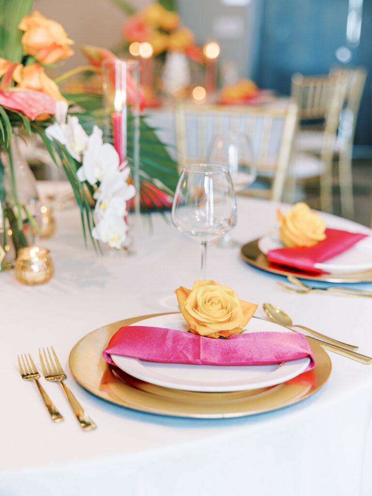 Colorful Table Setting with Floral Centerpieces and Gold Accents