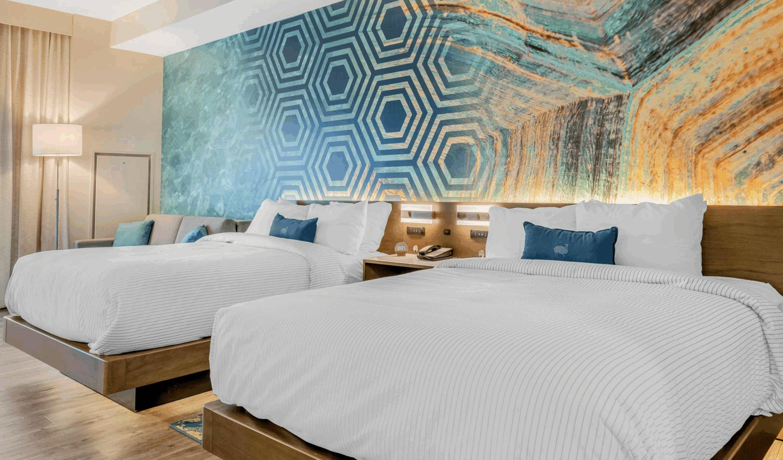 Hotel Room with Two Beds and Decorative Blue Accent Wall