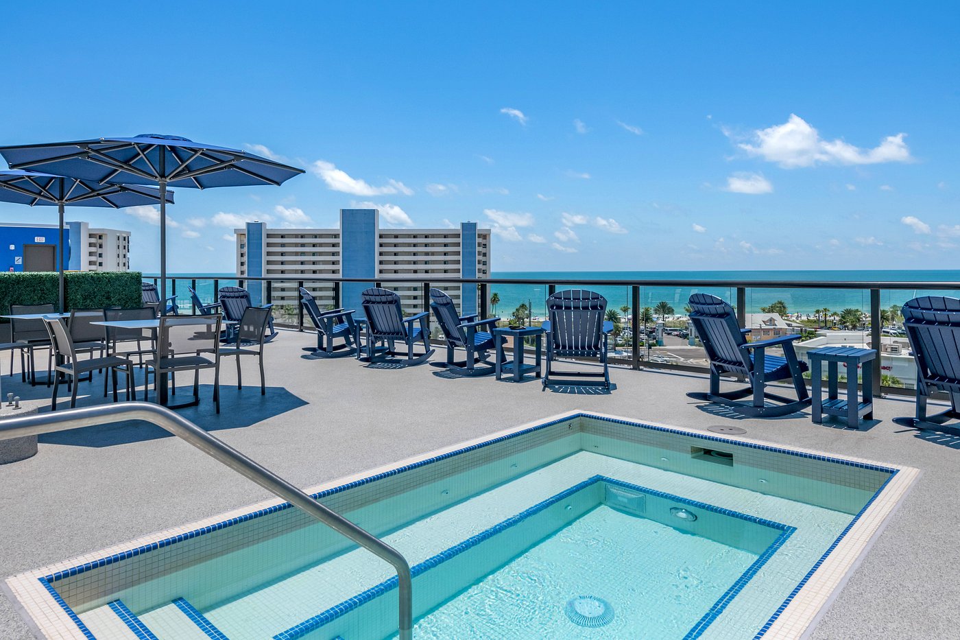 Rooftop Pool Deck with Lounge Chairs and Skyline View