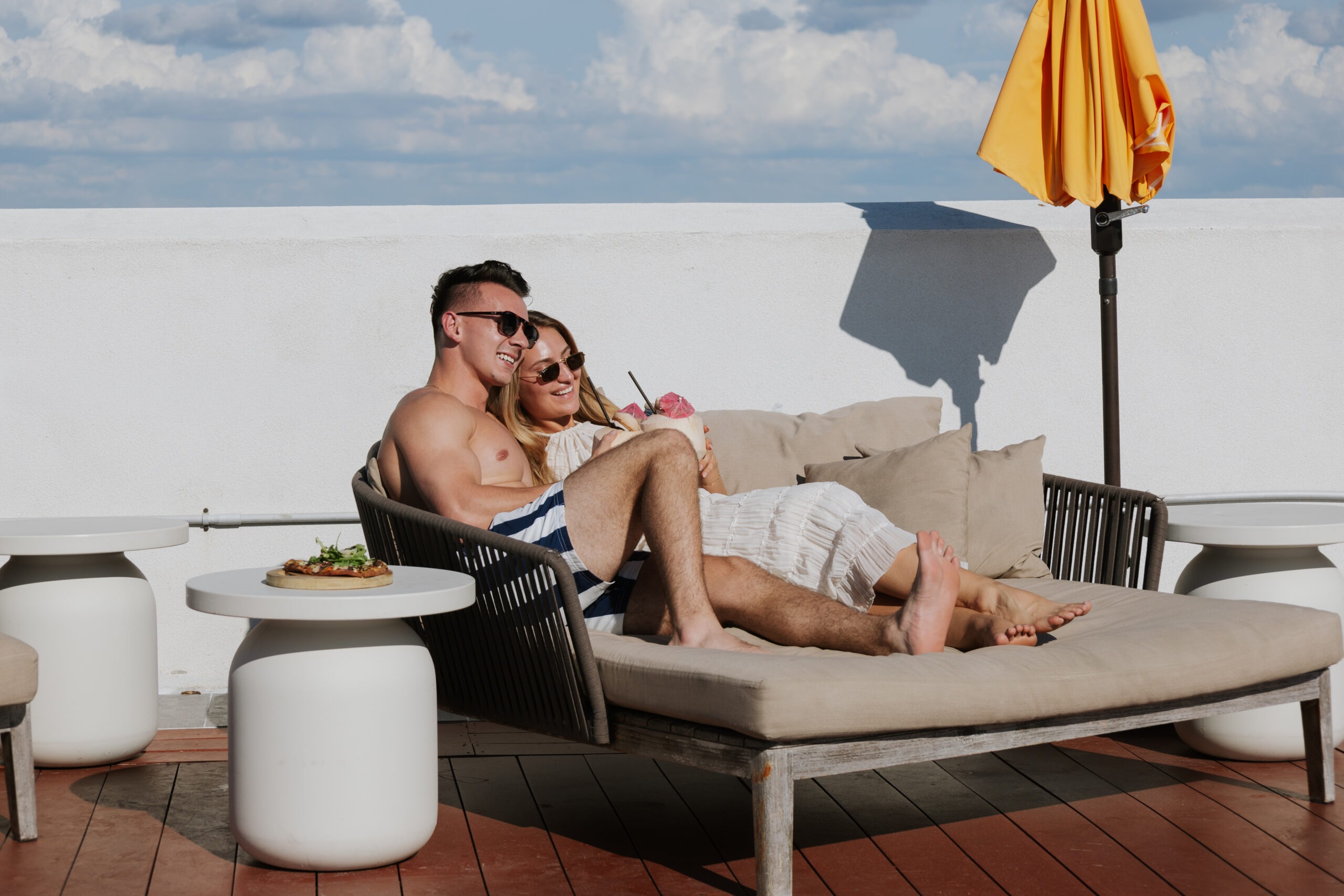 Man and Woman Relaxing on a Rooftop Lounge Chair