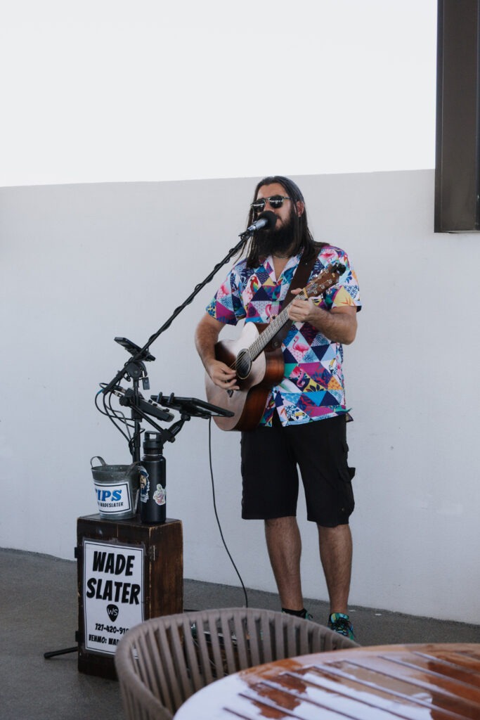 Musician Performing Outdoors with Guitar and Microphone