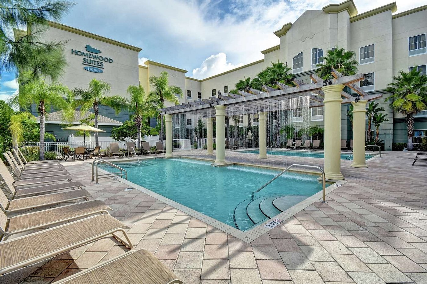 Outdoor Pool Area with Lounge Chairs and Pergola